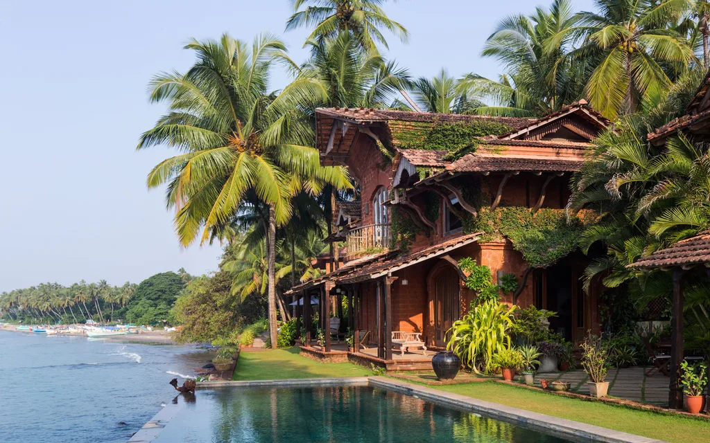 coconut trees beside a rest house in goa beach