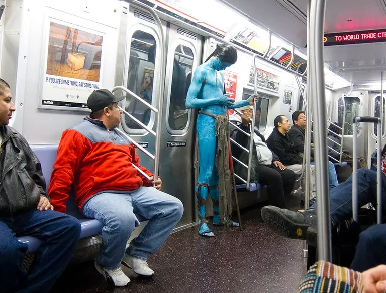 One of the passengers on a New York subway is dressed like an Avatar character.
