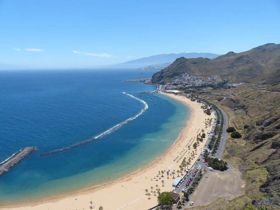 A sandy shoreline in Tenerife under sunny skies