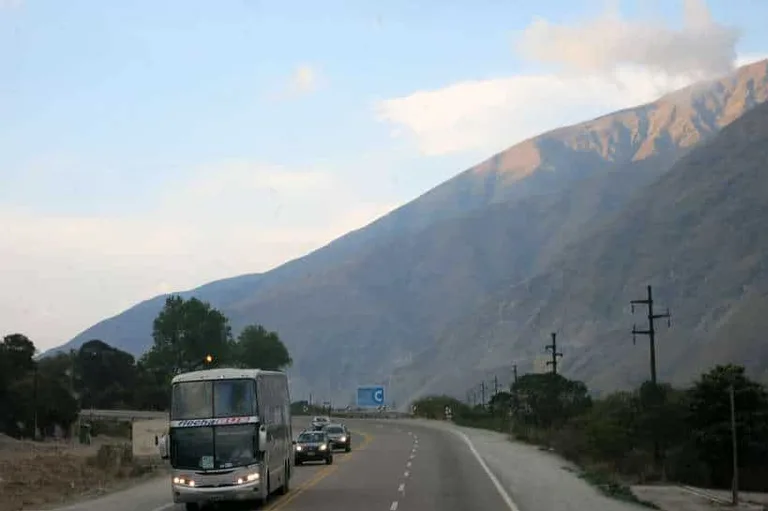 Bus on streeet with mountain view in the background