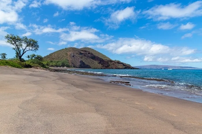 Beautiful sandy beach with volcano in the background
